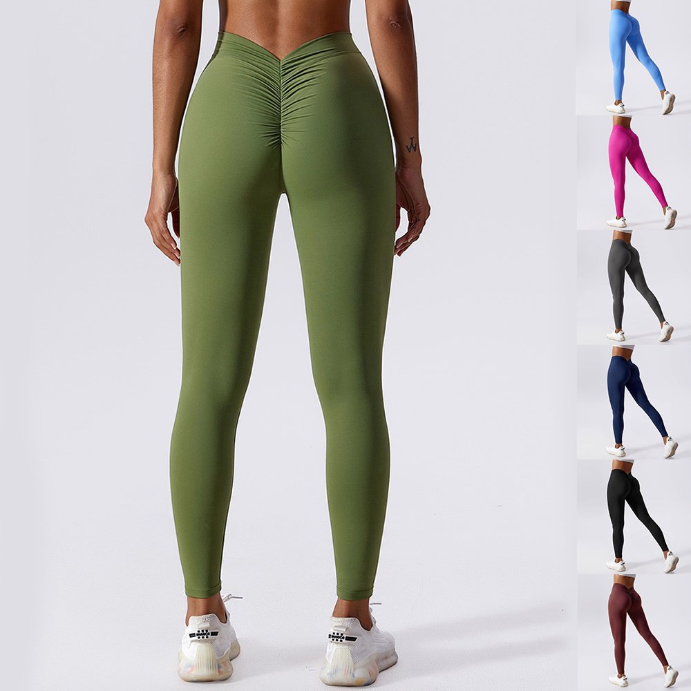 Pantalones de yoga ajustados y transpirables de secado rápido para mujer, mallas de realce de cadera en color melocotón.